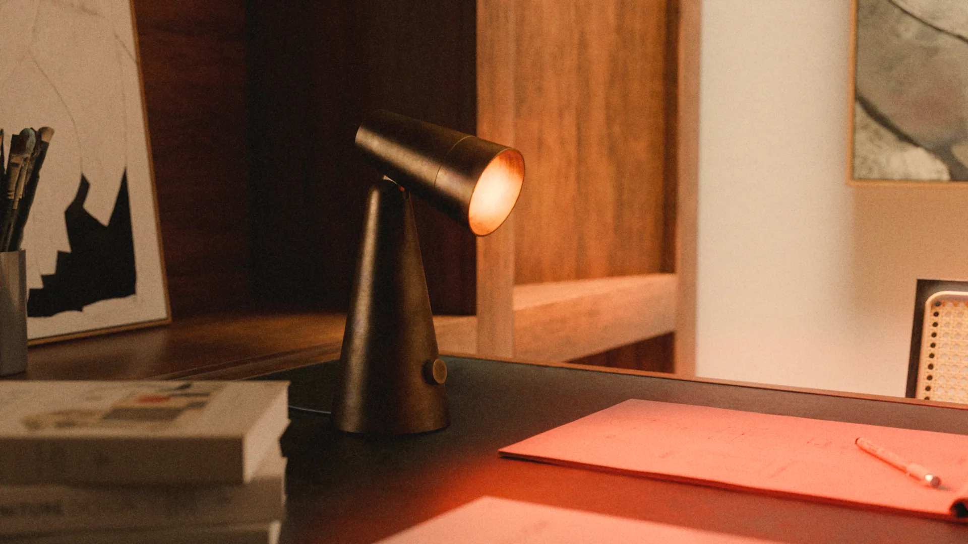 Table Lamp 001 on a desk beside books and framed art